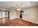 Dining room space showcasing hardwood floors, light colored walls, chandelier, and transition to kitchen area at 3753 S Rosecrest Cir, Las Vegas, NV 89121