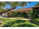 Landscaped front yard with mature trees and green lawn, complementing this single-story home's curb appeal at 3753 S Rosecrest Cir, Las Vegas, NV 89121