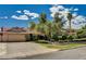 A single-story home with tan siding, a red roof, a two-car garage, and mature trees in the front yard at 3753 S Rosecrest Cir, Las Vegas, NV 89121