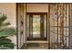 Close-up of a front door with decorative glass and iron security gate in front of a house at 3753 S Rosecrest Cir, Las Vegas, NV 89121