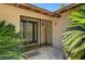 Inviting front entrance with secure iron gate, palm trees, and a decorative hummingbird feeder at 3753 S Rosecrest Cir, Las Vegas, NV 89121