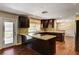 Bright kitchen with dark wood cabinets, stainless steel appliances, and a view of the outdoor patio at 3753 S Rosecrest Cir, Las Vegas, NV 89121