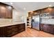 A kitchen featuring wooden cabinets, stainless steel appliances, and a tile backsplash at 3753 S Rosecrest Cir, Las Vegas, NV 89121