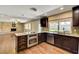 Open concept kitchen with stainless steel appliances, granite countertops, and wood flooring at 3753 S Rosecrest Cir, Las Vegas, NV 89121