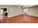 Open floor plan, with wood floors, seamlessly connects the living and kitchen areas at 3753 S Rosecrest Cir, Las Vegas, NV 89121