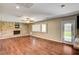 Open living room featuring wood floors, stone fireplace, bright windows and outdoor access at 3753 S Rosecrest Cir, Las Vegas, NV 89121