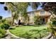 The backyard's lush lawn, landscaping, and inviting seating area offer a perfect outdoor retreat at 4017 Kristina Lynn Ave, North Las Vegas, NV 89081