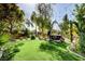 The backyard features an inviting green lawn, landscaping, seating area, and string lights at 4017 Kristina Lynn Ave, North Las Vegas, NV 89081