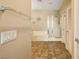 Bathroom featuring a soaking tub, glass-enclosed shower, tile flooring and neutral color palette at 4017 Kristina Lynn Ave, North Las Vegas, NV 89081