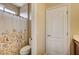 This bathroom has a shower/bath combo with a toilet and a door at 4017 Kristina Lynn Ave, North Las Vegas, NV 89081