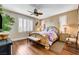 Bedroom with hardwood floors, shuttered windows, and decorative ceiling fan at 4017 Kristina Lynn Ave, North Las Vegas, NV 89081