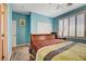 This bedroom features a wooden bed frame, a window with shutters, and a ceiling fan at 4017 Kristina Lynn Ave, North Las Vegas, NV 89081