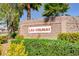The neighborhood entrance sign 'Las Colinas' is surrounded by lush greenery, creating an inviting entrance at 4017 Kristina Lynn Ave, North Las Vegas, NV 89081