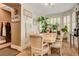 Bright dining room features a marble table, six chairs, plantation shutters, and decorative plants at 4017 Kristina Lynn Ave, North Las Vegas, NV 89081
