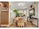 Bright dining room features a marble table, six chairs, plantation shutters, and decorative plants at 4017 Kristina Lynn Ave, North Las Vegas, NV 89081