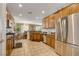 Spacious kitchen featuring stainless steel appliances, granite countertops, and tile flooring at 4017 Kristina Lynn Ave, North Las Vegas, NV 89081