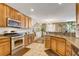 Well-lit kitchen featuring granite countertops, stainless steel appliances, and ample wood cabinetry at 4017 Kristina Lynn Ave, North Las Vegas, NV 89081