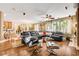 Cozy living room featuring a black leather sectional sofa, hardwood floors, and decorative plants at 4017 Kristina Lynn Ave, North Las Vegas, NV 89081