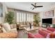 Neutral living room showcasing shuttered windows, sofa set and a ceiling fan at 4017 Kristina Lynn Ave, North Las Vegas, NV 89081
