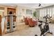 Open living room with exercise equipment, shuttered windows and neutral tones at 4017 Kristina Lynn Ave, North Las Vegas, NV 89081