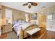 A well lit main bedroom shows plantation shutters, decorative ceiling fan, and hardwood floors at 4017 Kristina Lynn Ave, North Las Vegas, NV 89081