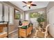 This home office has a desk, two windows with shutters, and a ceiling fan with light at 4017 Kristina Lynn Ave, North Las Vegas, NV 89081