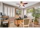 This well-lit office features two windows with shutters, a ceiling fan, and neutral colored walls at 4017 Kristina Lynn Ave, North Las Vegas, NV 89081