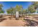 Community baseball field featuring a manicured infield, trees and a nearby community information board at 489 Filaree Pl, Henderson, NV 89015