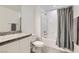 Charming bathroom with granite counters, white cabinets and shower-tub combination at 489 Filaree Pl, Henderson, NV 89015