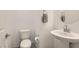 Contemporary half bathroom features a pedestal sink, and a sleek modern design at 489 Filaree Pl, Henderson, NV 89015