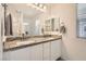 Elegant bathroom featuring a granite-topped double vanity and modern fixtures at 489 Filaree Pl, Henderson, NV 89015