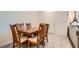 Traditional dining room featuring a wooden table with six chairs, offering ample space at 489 Filaree Pl, Henderson, NV 89015