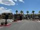 Welcoming entrance to Juniper Trails, lined with palm trees, showcasing a well-maintained community at 489 Filaree Pl, Henderson, NV 89015