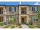 Inviting townhome exterior with private balcony, landscaping, enhancing curb appeal and community ambiance at 489 Filaree Pl, Henderson, NV 89015