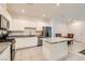Modern kitchen featuring white cabinets, granite countertops, stainless steel appliances and a breakfast bar at 489 Filaree Pl, Henderson, NV 89015