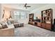 Spacious living room featuring plush carpet, media center, and comfortable seating at 489 Filaree Pl, Henderson, NV 89015