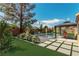 Backyard rendering showcases a luxurious pool, patio, lush greenery, and serene desert landscaping at 5005 Chambliss Dr, Las Vegas, NV 89130
