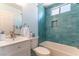 Well-lit bathroom featuring a combined tub and shower with bright blue accent tile at 5005 Chambliss Dr, Las Vegas, NV 89130