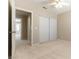 Bright, neutral bedroom with beige carpet, and an open doorway to the hallway at 5005 Chambliss Dr, Las Vegas, NV 89130