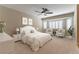 Bright bedroom featuring carpet, a ceiling fan, and white-framed windows with stylish shutters at 5005 Chambliss Dr, Las Vegas, NV 89130