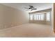 Spacious bedroom with large windows, white shutters, and a ceiling fan for comfort and natural light at 5005 Chambliss Dr, Las Vegas, NV 89130