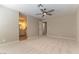 Bright bedroom with access to a bathroom, ceiling fan, and neutral carpeting at 5005 Chambliss Dr, Las Vegas, NV 89130