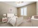This bedroom features neutral walls and carpet, a ceiling fan, and a window with white shutters at 5005 Chambliss Dr, Las Vegas, NV 89130