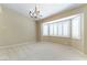 Bright dining room with bay window, chandelier, and neutral carpet at 5005 Chambliss Dr, Las Vegas, NV 89130