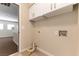 Well-lit laundry room with upper cabinets and convenient utility connections at 5005 Chambliss Dr, Las Vegas, NV 89130
