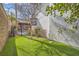 This backyard features a small patch of lawn and an outdoor kitchen with seating at 5367 Secluded Brook Ct, Las Vegas, NV 89149