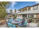 Luxurious backyard featuring an outdoor kitchen, fire pit, pool, and elegant architecture perfect for relaxation and entertainment at 5367 Secluded Brook Ct, Las Vegas, NV 89149