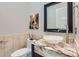 Elegant powder room featuring a marble countertop, vessel sink, and stylish decor at 5367 Secluded Brook Ct, Las Vegas, NV 89149