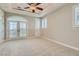 Spacious bedroom with carpeted floors and french doors that offer access to a balcony at 5367 Secluded Brook Ct, Las Vegas, NV 89149