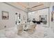 Elegant dining room with a modern chandelier, glass table, and contemporary decor, offering a stylish space for entertaining at 5367 Secluded Brook Ct, Las Vegas, NV 89149